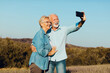 © Lumos sp - woman man outdoor senior couple happy lifestyle retirement together smiling love selfie camera mature