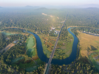 Wall Mural - The beautiful Deschutes River winds through the rural landscape near Sunriver, Oregon. This area, in the foothills of the Cascade Mountains, is a popular vacation destination in the summer and winter.