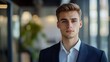 © SprintZz - photography of a young entrepreneur with a determined expression, the portrait image reflecting his ambition and drive to succeed in the business world, blurred office as background