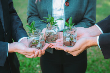 Wall Mural - Concept of sustainable money growth investment with glass jar filled with money savings coins with businesspeople as eco-friendly financial investment nurtured with nature and healthy retirement. Gyre