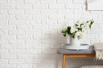 Wall Mural - Vase with lilac flowers on soft bench in room