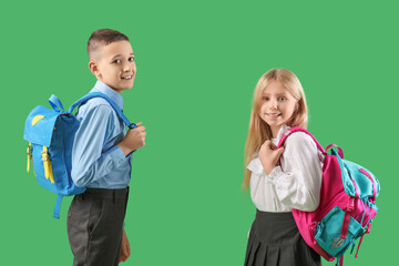 Poster - Cute pupils with backpacks on green background