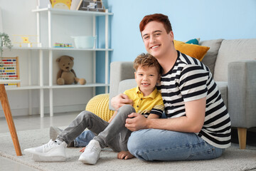 Sticker - Little boy with his father hugging on floor at home