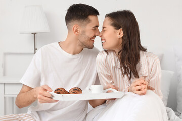 Canvas Print - Young woman receiving breakfast in bed from her beloved boyfriend