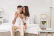© Pixel-Shot - Happy young couple together in bedroom
