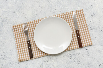 Sticker - Table setting with plate, cutlery and napkin on white grunge background