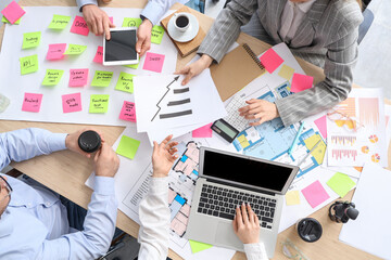 Canvas Print - Business people working on house plan at table in office, top view