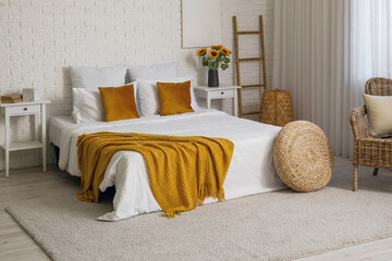 Poster - Interior of bedroom with ladder, pouf and artificial sunflowers in vase