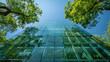 © MuhammadRiasqa - A clear glass building with green trees and a blue sky