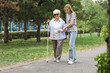 © Pixel-Shot - Blind senior woman with her granddaughter walking in park