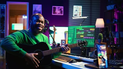 Leinwandbilder - Talented performer teaching how to play acoustic guitar online for a tutorial, hosting internet master class to provide advice for beginners. Artist composer explaining accords on strings. Camera B.