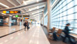 © Aiustock - Blurred Motion of People Walking Through an Airport Terminal