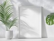 © IttikornP - Minimalist white frame with a blank poster mockup, placed on a white table with soft natural light