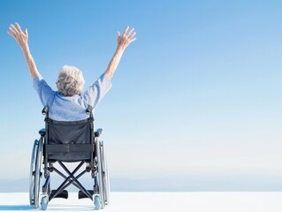 An elderly person in a wheelchair raises their arms in joy against a bright blue sky, symbolizing freedom and empowerment.