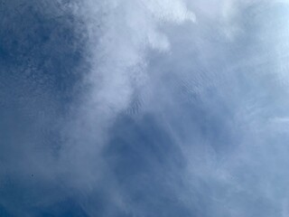 Wall Mural - an image of a sky with thinly scattered white clouds and bright light.