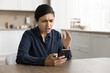 © fizkes - Frustrated young woman hold smartphone, read bad news, received unpleasant message in email, dissatisfied with broken phone, slow internet connection, have problems with digital device, feels stress