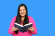 © Arlette - 40 year old Latina woman reads a book as study and entertainment to relax and enjoy her free time on vacation weekend