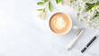 © atthameeni - A flat lay of a coffee cup on a white marble desk with copy space for text