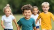 © iamtopkritsada - A cheerful boy leads a group of friends in a playful run through a sunny field, showcasing joy and friendship in childhood.