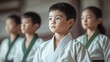 © iamtopkritsada - Focused child in martial arts attire practicing concentration and discipline in a traditional dojo setting.
