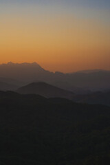 Wall Mural - nature traveling with orange sky and layer of mountain with sunrise background