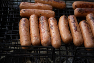 Wall Mural - Charcoal sausages. Food in the air. Meat sausages on fire.