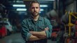 © liliyabatyrova - A man in a blue jacket is standing in a garage with his arms crossed