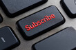 © watz - Red Subscribe key on a black keyboard.