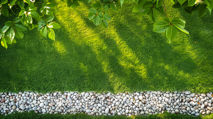 A beautiful, well-trimmed lawn with a path lined with white pebbles. Landscape design, gardening, natural background, top view.	