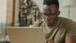 © LukaszDesign - Plans, remote work, laptop, serious soldier, and black man typing at home table. Computer, internet veteran, office technology for army freelancer, search and read military email.