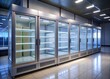 © Wanlop - A vacant commercial freezer stands alone in an empty retail store, its glass door and metal shelves gleaming under the fluorescent lighting.