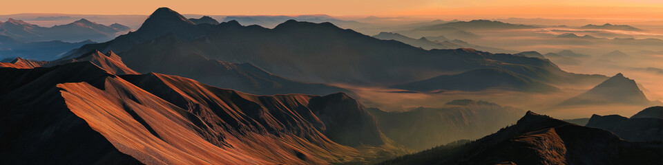Wall Mural - the mountains are covered in fog and the sun is setting