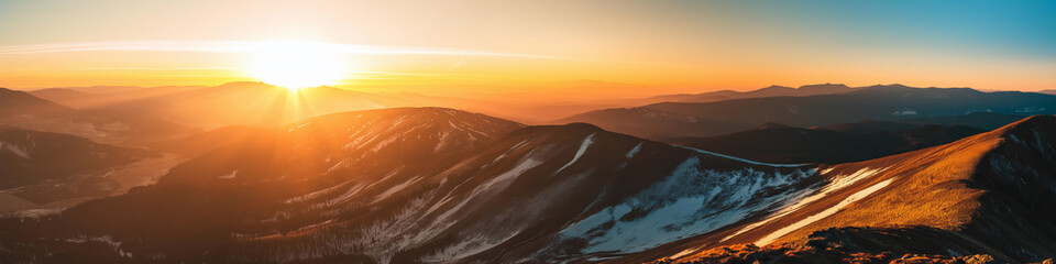 Wall Mural - the sun is setting over a mountain range, casting a warm glow over the landscape