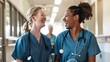 © Zainab - Two nurses sharing a laugh and conversation in a hospital setting. Concept Nursing, Workplace Interaction, Healthcare Communication, Laughter, Team Bonding
