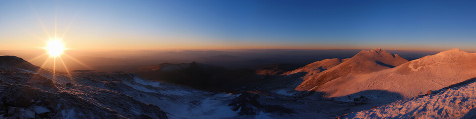 Wall Mural - a beautiful mountain range with a sun shining on it