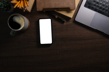 Wall Mural - Modern workplace with smart phone notebook on wooden table. Copy space and blank screen for your advertise design.