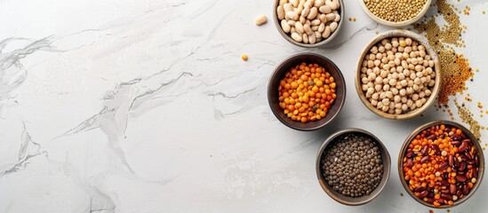 Poster - Assorted legumes lentils chickpeas and beans in various bowls on a white table Top view with copyspace