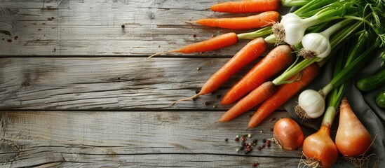 Poster - Fresh carrot and spring onion on a wooden table surface with copy space image