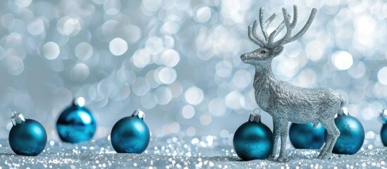 Poster - Silver Elk Christmas ornaments and Blue Christmas balls on a glittery Silver background with copy space image