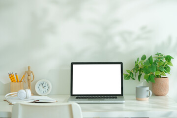 Wall Mural - Mockup computer laptop, coffee cup, books and pencil holder on white table.