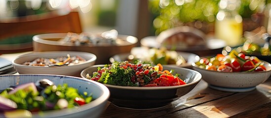 Poster - A table set with plates of delicious food and bowls of fresh salad creating an appealing copy space image