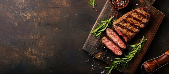 Poster - A succulent grilled beef steak on a rustic table with a copy space image as a appetizing and healthy meal option shown from a top view