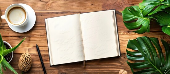 Poster - Wooden desk with a blank open notebook mockup featuring empty pages perfect for branding top view shot with ample copy space image