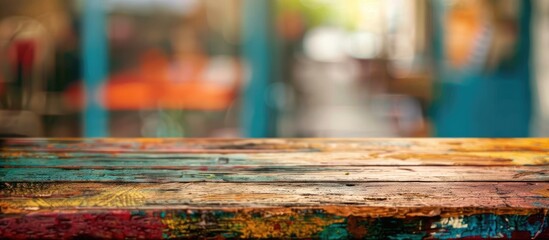Aufkleber - A weathered colorful table with visible wear marks offers a grungy backdrop with a blurred background ideal for a copy space image