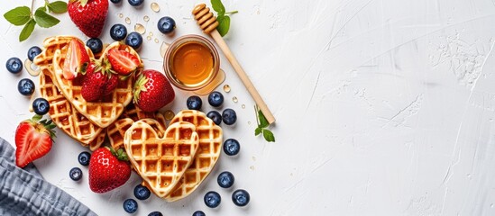 Aufkleber - Heart shaped homemade Belgian waffles topped with fresh strawberries blueberries and honey displayed on a white kitchen table with space for images. Creative banner. Copyspace image