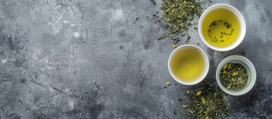 Aufkleber - Top view of Green Sencha tea infused with floral and fruity notes set against a grey concrete backdrop providing ample copy space image