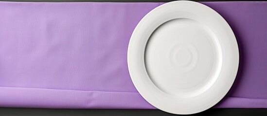 Sticker - White dinner plate showcased with a rolled purple table linen creating an elegant setting against a blank canvas with copy space image