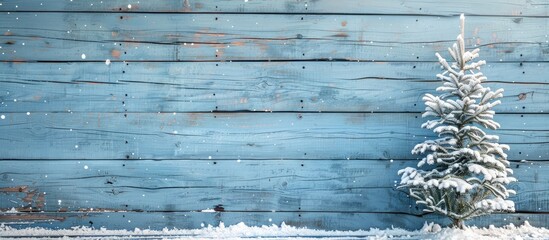 Canvas Print - Snow made Christmas tree with natural decor on blue wood ideal for creative Christmas themed copy space images