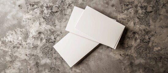 Wall Mural - Top view of blank business cards on a grey textured background ideal for design mockup with copy space image