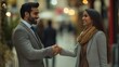 © The Little Hut - Indian businessman greeting and making handshake with a businesswoman outdoors in city walkway : Generative AI